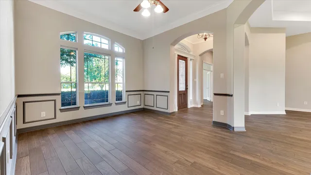 wooden floor in an empty room with a window