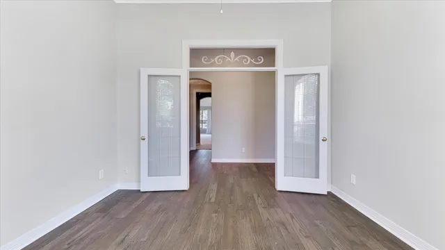 a view of an empty room with wooden floor