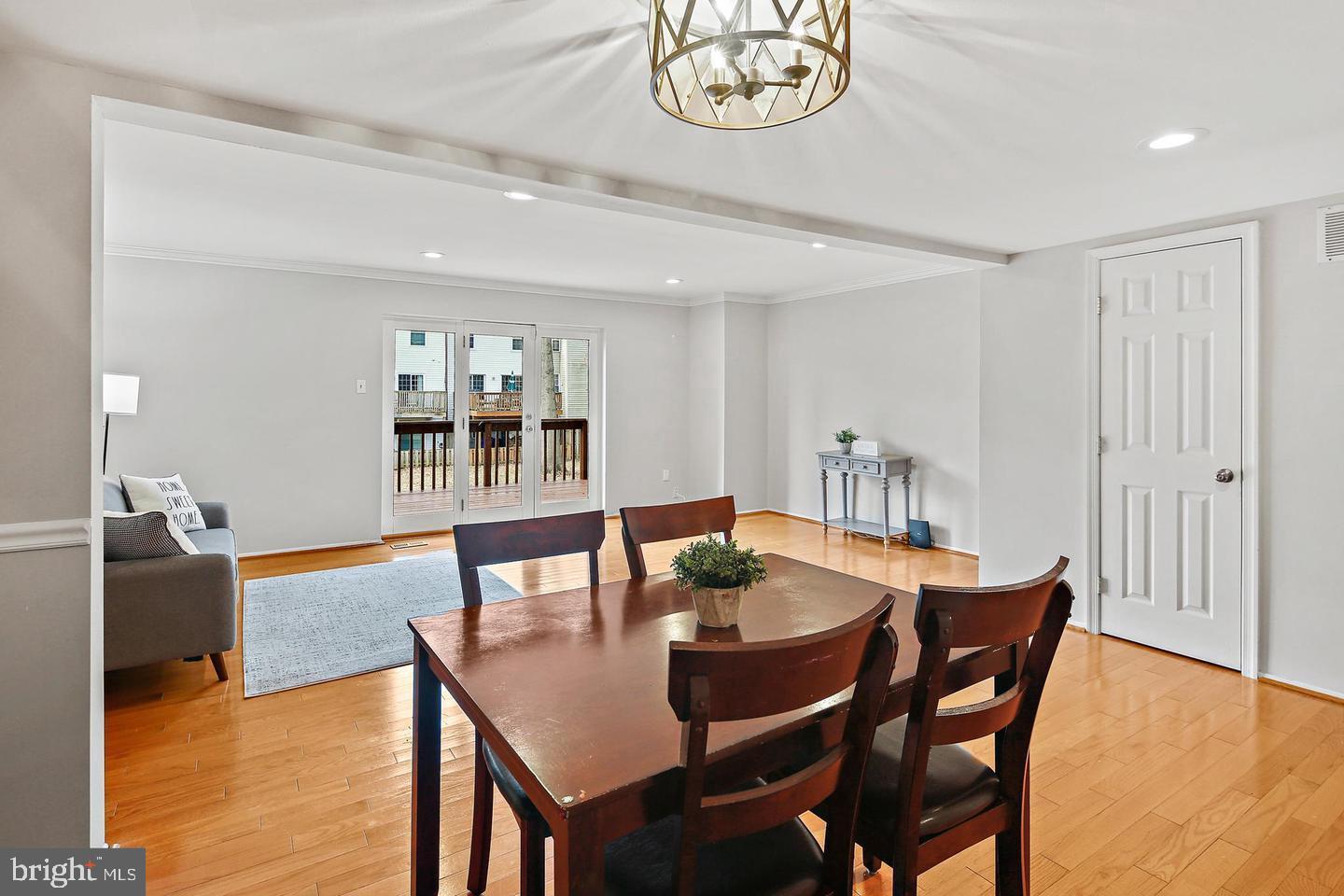 7068 Winter Rose Path Columbia, MD 21045 - Photo 11 of 30 a view of a dining room with furniture and wooden floor