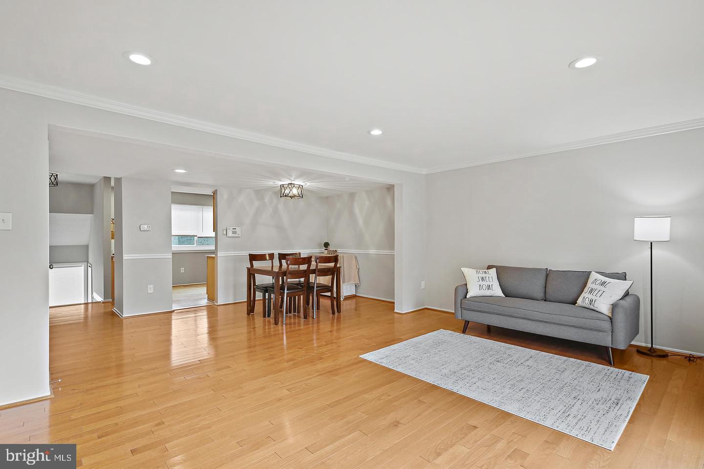 7068 Winter Rose Path Columbia, MD 21045 - Photo 12 of 30 a living room with furniture and a dining table with kitchen view