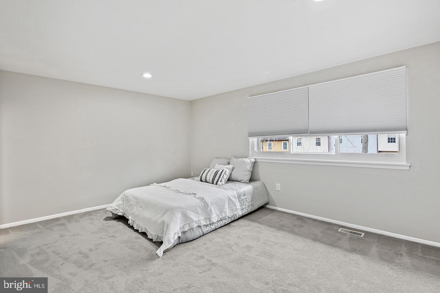 7068 Winter Rose Path Columbia, MD 21045 - Photo 14 of 30 a bedroom with a bed and a night stand