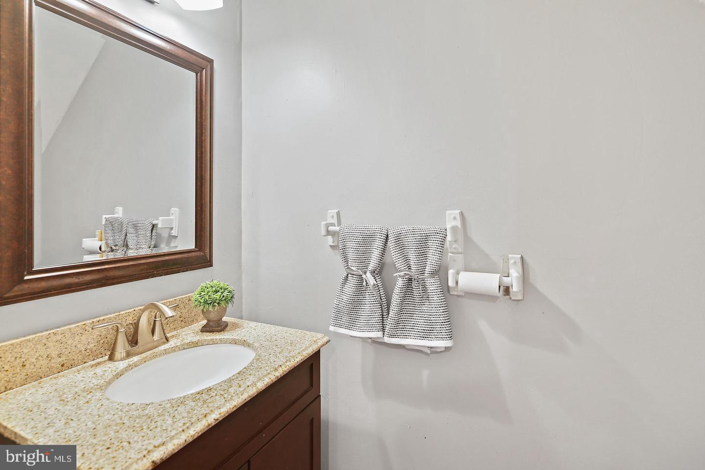 7068 Winter Rose Path Columbia, MD 21045 - Photo 15 of 30 a bathroom with a granite countertop sink a mirror and a window