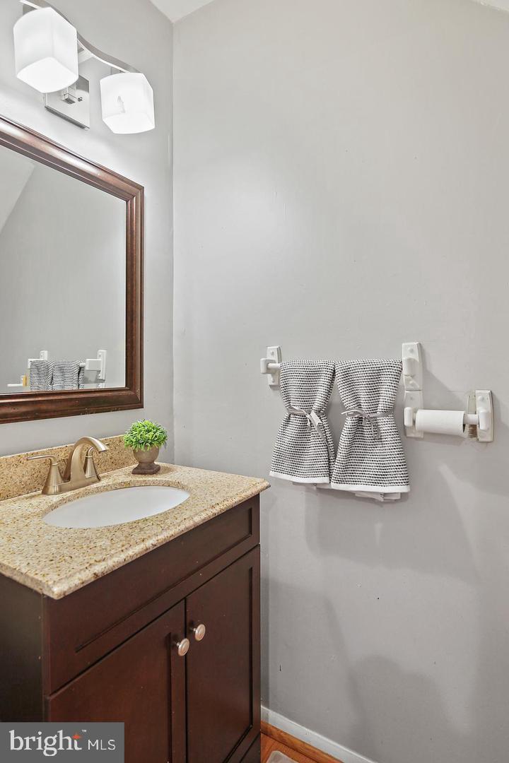 7068 Winter Rose Path Columbia, MD 21045 - Photo 16 of 30 a bathroom with a granite countertop sink and a mirror