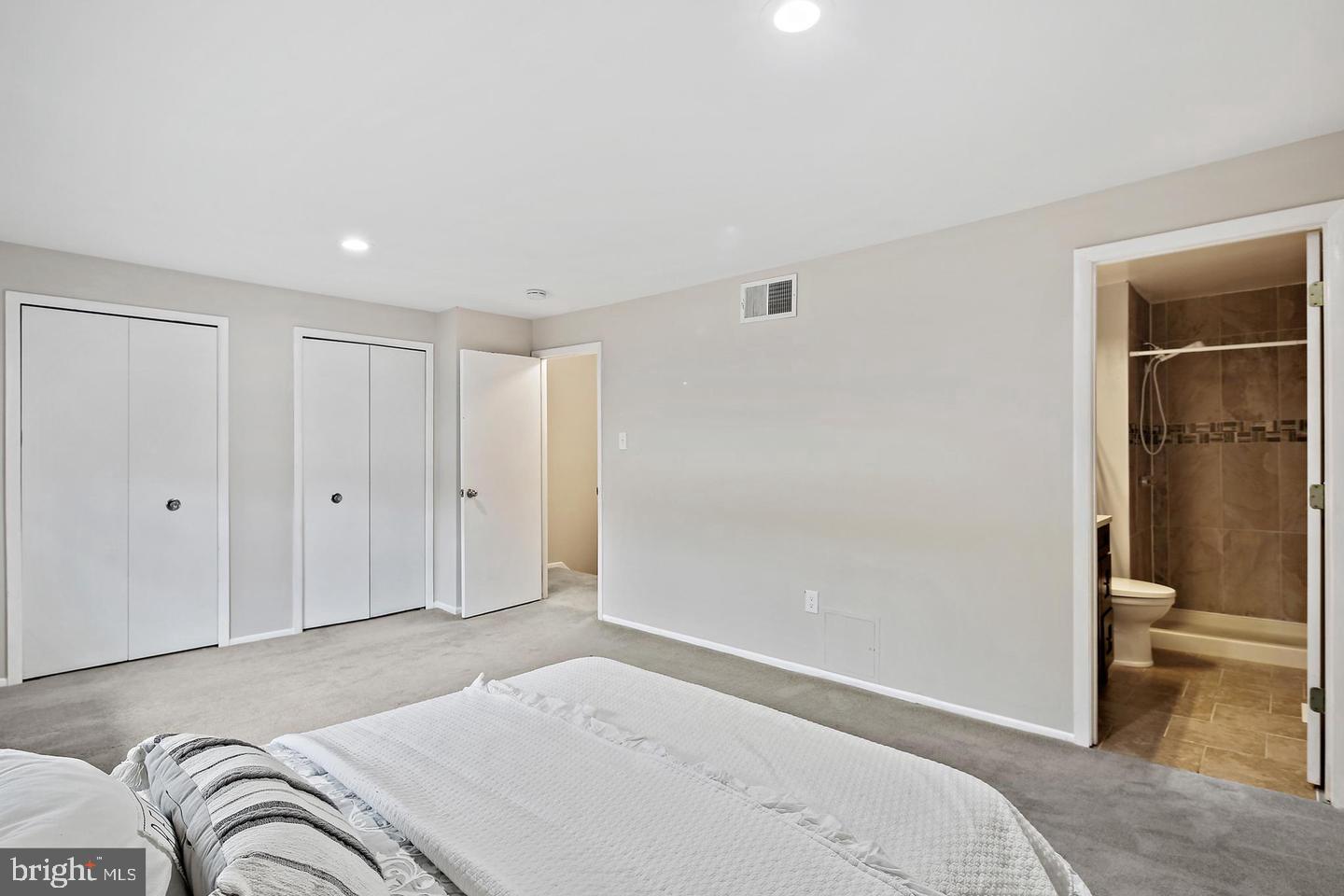 7068 Winter Rose Path Columbia, MD 21045 - Photo 17 of 30 a bedroom with a bed and bathroom