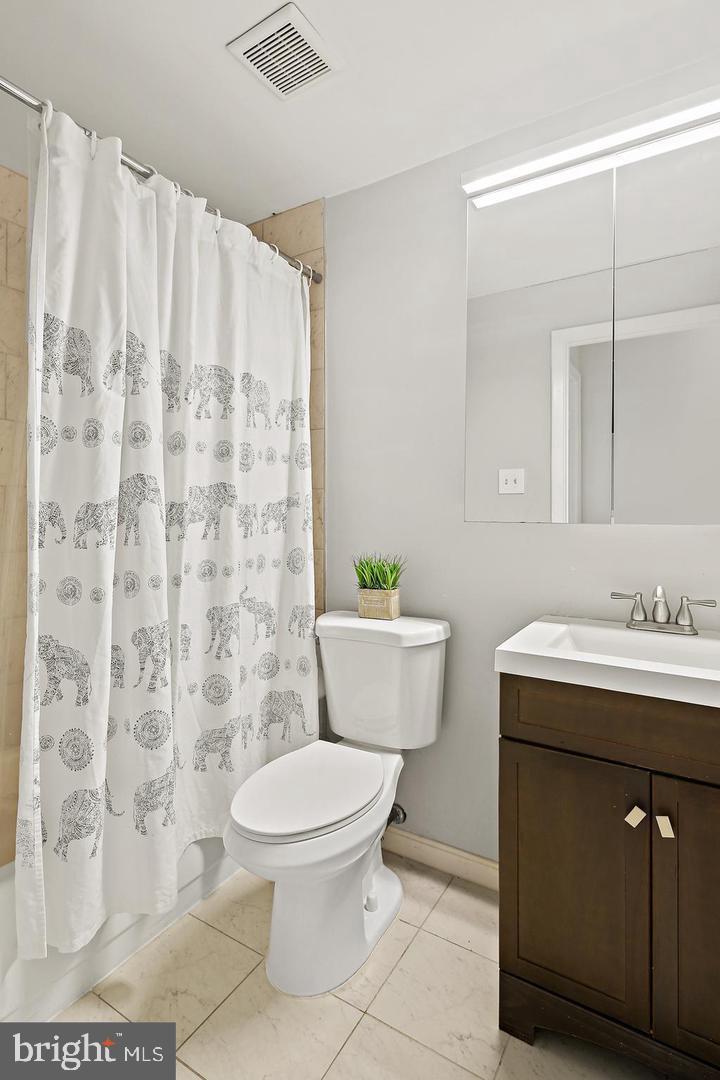 7068 Winter Rose Path Columbia, MD 21045 - Photo 21 of 30 a bathroom with a granite countertop toilet sink and mirror