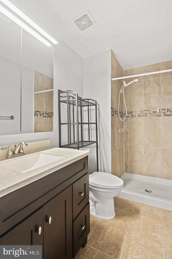 7068 Winter Rose Path Columbia, MD 21045 - Photo 22 of 30 a bathroom with a sink toilet vanity and shower