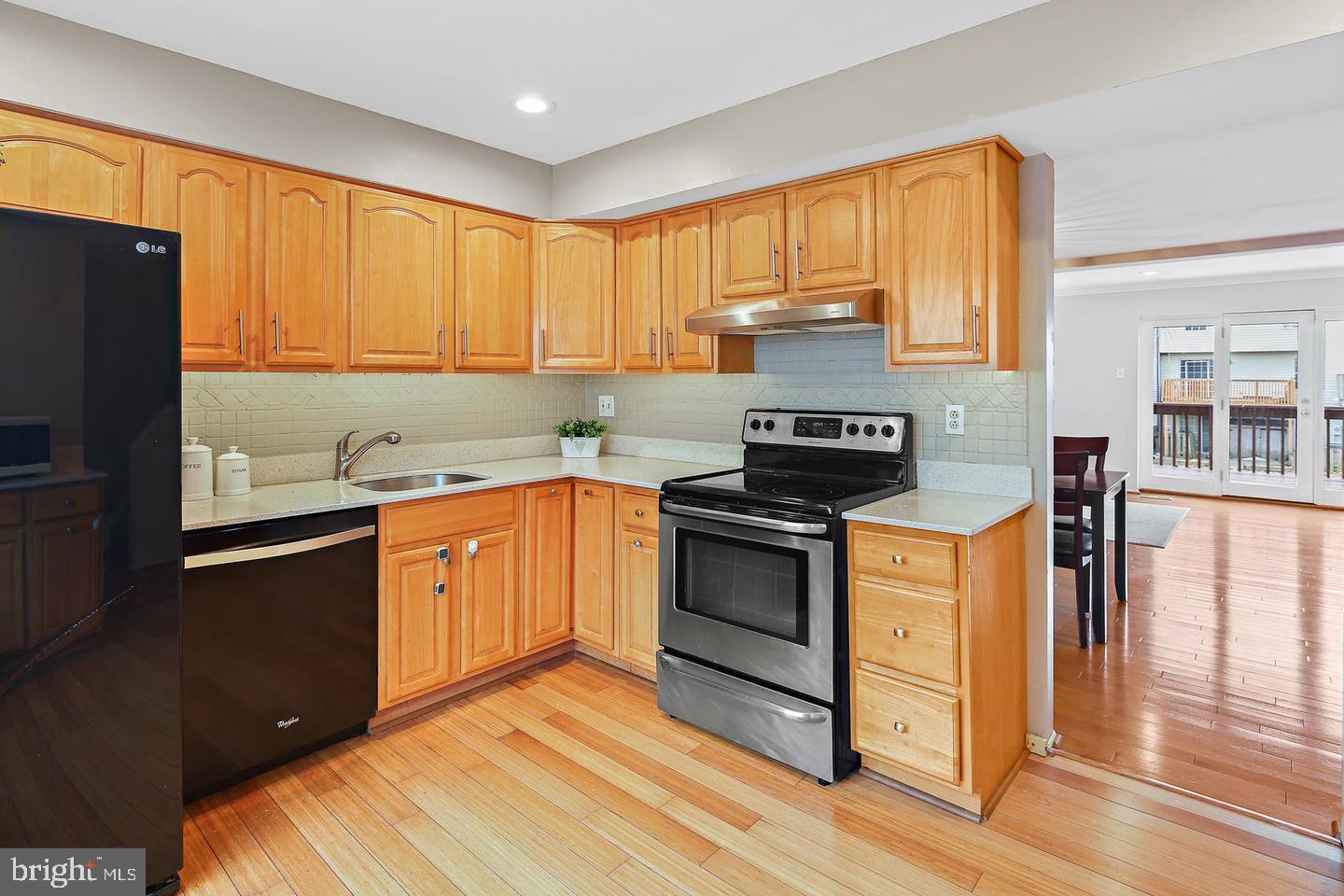 7068 Winter Rose Path Columbia, MD 21045 - Photo 6 of 30 a kitchen with stainless steel appliances granite countertop a stove a sink and a refrigerator