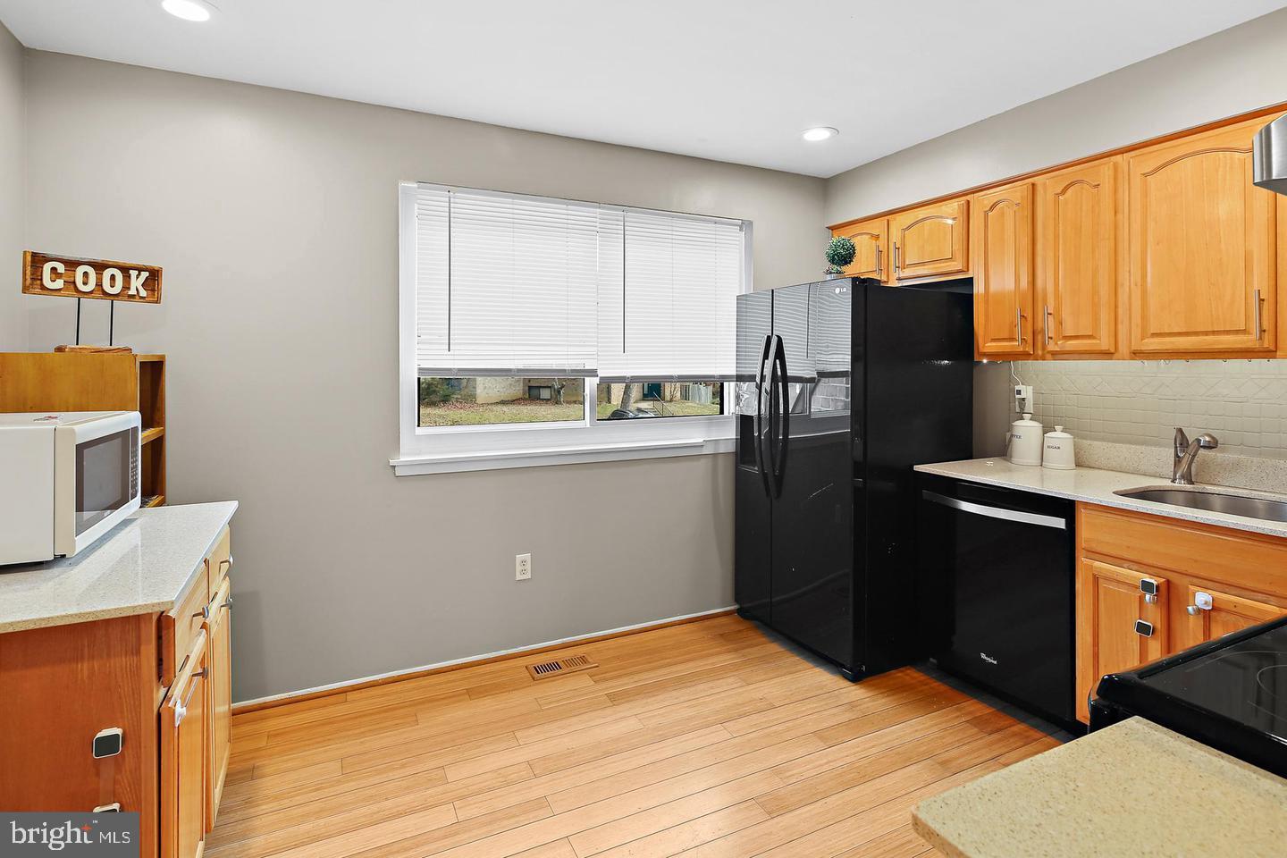 7068 Winter Rose Path Columbia, MD 21045 - Photo 8 of 30 a kitchen with a refrigerator and a sink