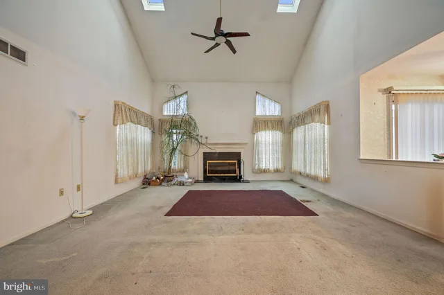 a view of a livingroom with a fireplace and window