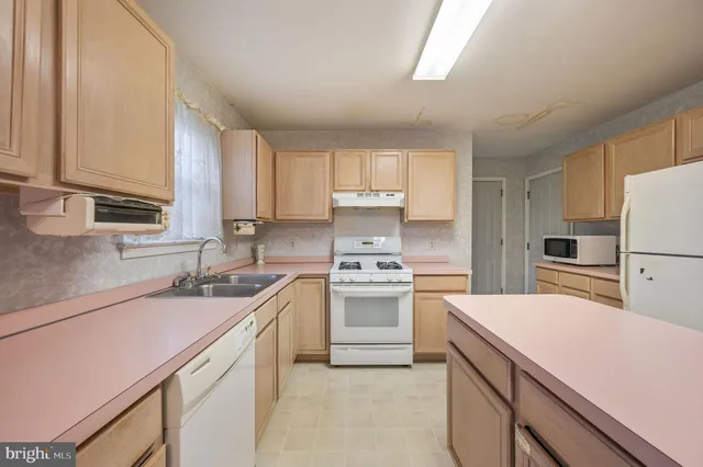 a kitchen with stainless steel appliances a sink stove and cabinets