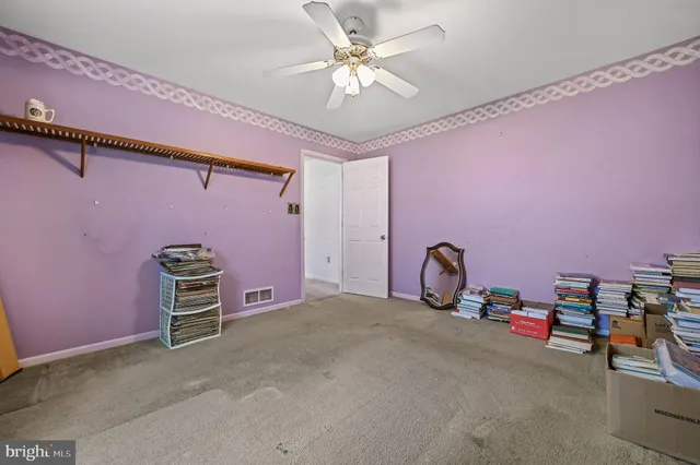 a view of a hallway with wooden floor and stairs