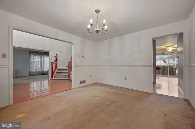 wooden floor in an empty room with a bathroom