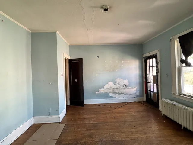 a view of a room with wooden floor and stairs