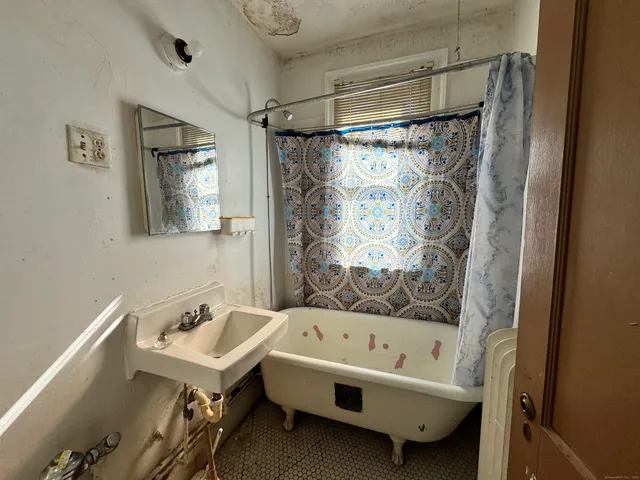 a front view of a house with a green gate