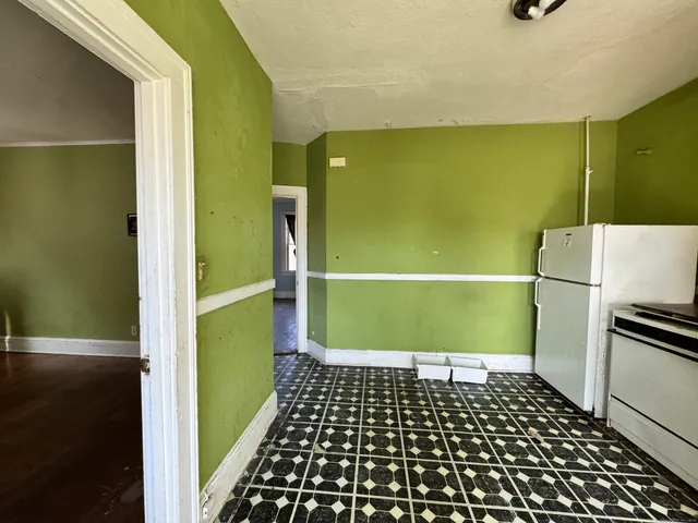 a view of a big room with wooden floor and windows
