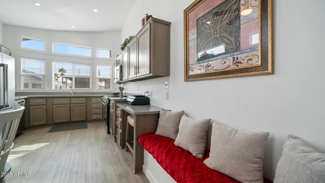 a kitchen with a refrigerator a sink and white cabinets