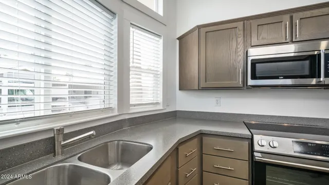 a bathroom with a granite countertop sink toilet and mirror