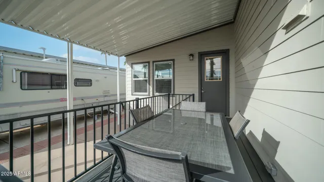 a view of a patio with chairs and a grill
