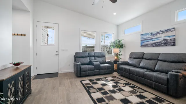 a living room with furniture and a wooden floor