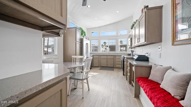 a kitchen with stainless steel appliances granite countertop a stove a sink and a refrigerator