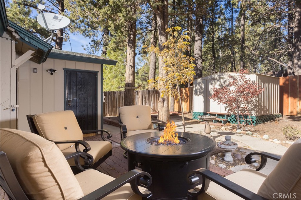 43014 Moonridge Road Big Bear Lake, CA 92315 - Photo 6 of 22 a view of a patio with table and chairs
