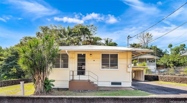 a view of a white house with a swimming pool