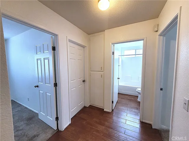 a view of a hallway with wooden floor