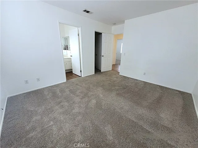 an empty room with closet area