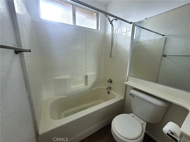 a bathroom with a toilet and a bathtub