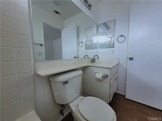 a bathroom with a sink a toilet and a mirror