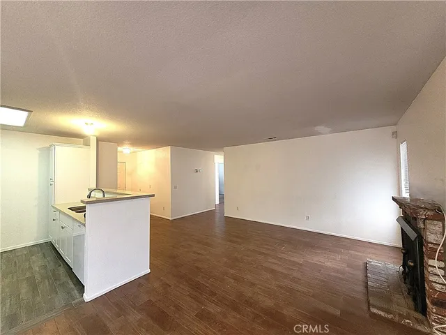 a kitchen with a sink cabinets and wooden floor