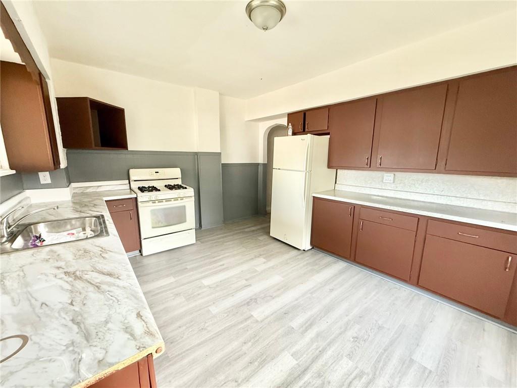 864 Vankirk Street Clairton, PA 15025 - Photo 3 of 10 a kitchen with a refrigerator sink stove and oven