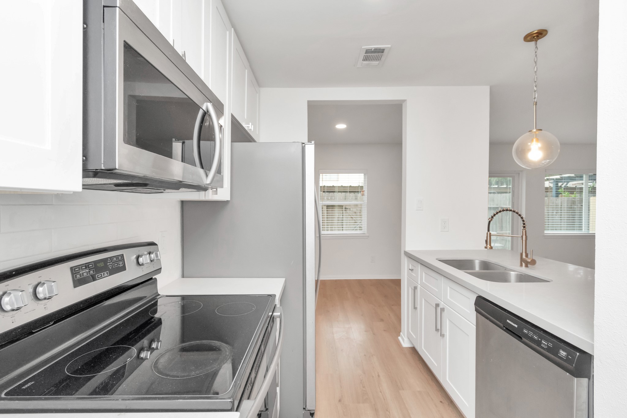 1365 Country Pl Drive Houston, TX 77079 - Photo 13 of 35 a kitchen with a sink stove and cabinets