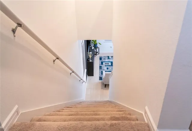 a bedroom with a bed and a potted plant