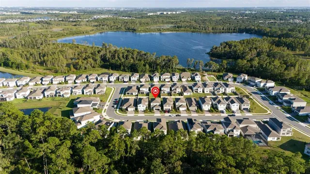 an aerial view of a house with a lake view