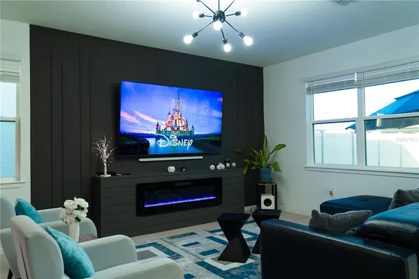 a room with furniture projector and screen