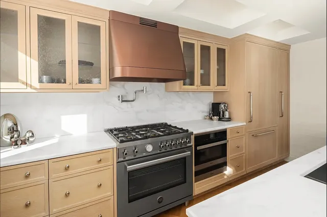 a kitchen with granite countertop white cabinets and stainless steel appliances