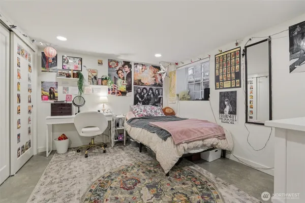 a spacious bedroom with a bed couch and a window