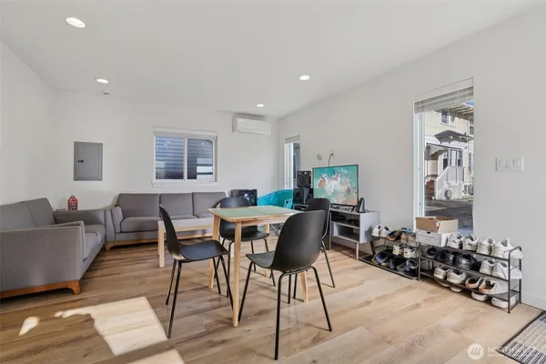 a view of a dining room with furniture and wooden floor