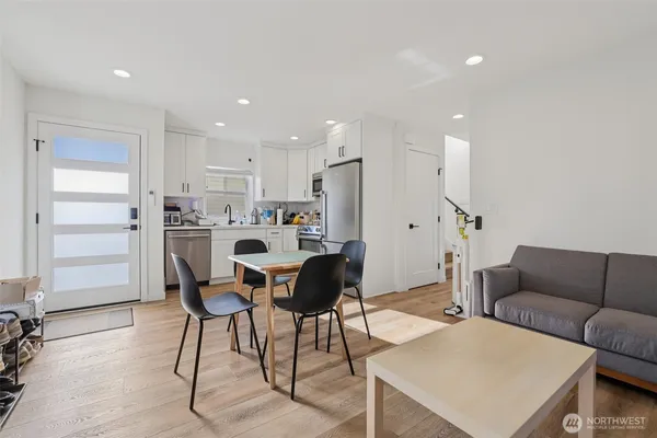 a living room with furniture and kitchen view