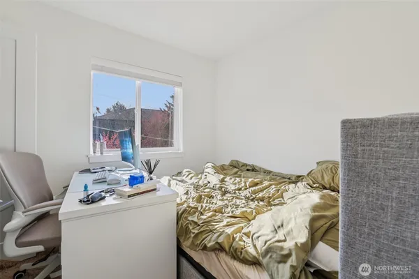 a bedroom with a bed and a window