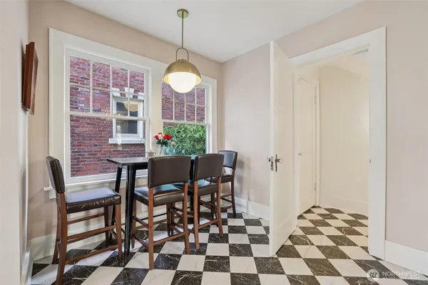a view of a dining room with a table and chairs