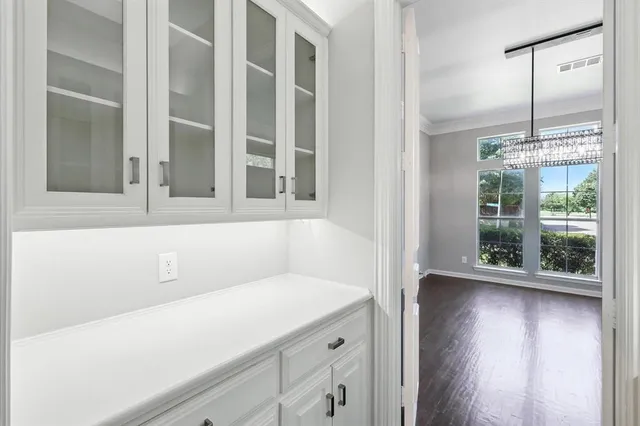 a kitchen with granite countertop a sink stainless steel appliances and cabinets