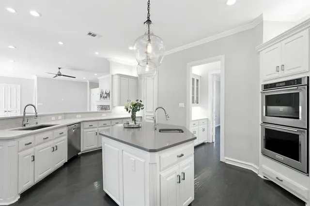a kitchen with center island a sink stainless steel appliances and cabinets