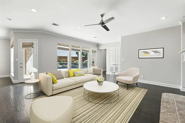 a living room with a fireplace and wooden floor