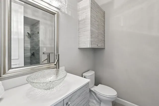 an empty room with windows and ceiling fan