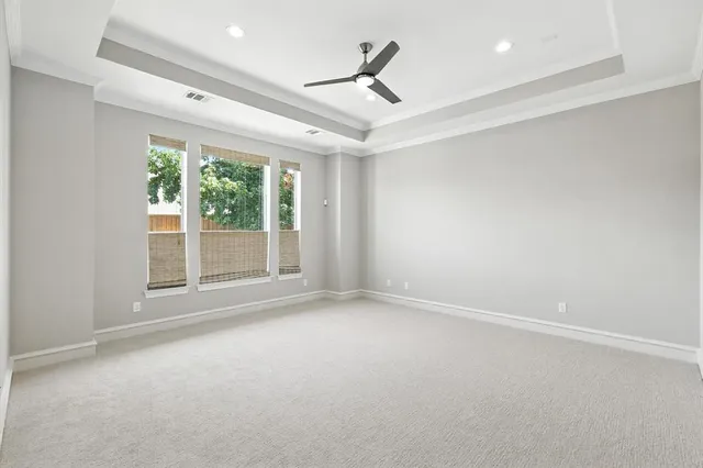 a bedroom with a bed a couch and a large window