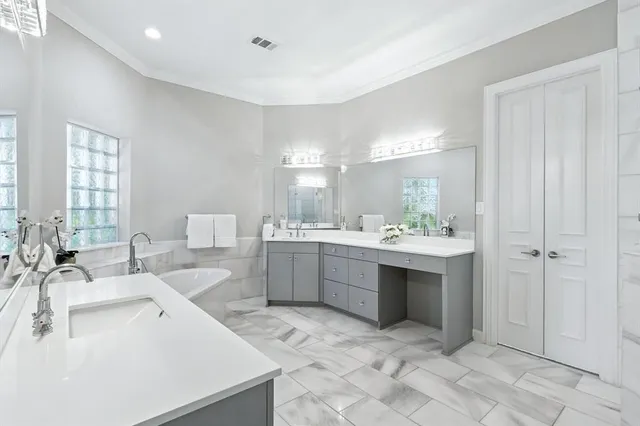 a bathroom with a double vanity sink mirror and shower