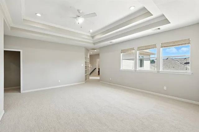 an empty room with windows and cabinet