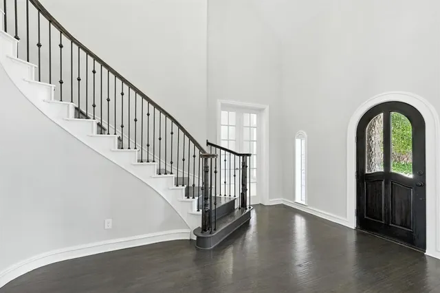 a view of entryway with wooden floor and stairs